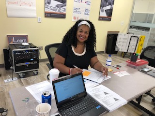 woman sitting at a table smiling