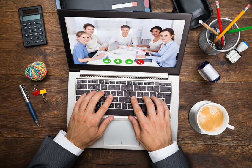 image of a man on a laptop in a virtual meeting