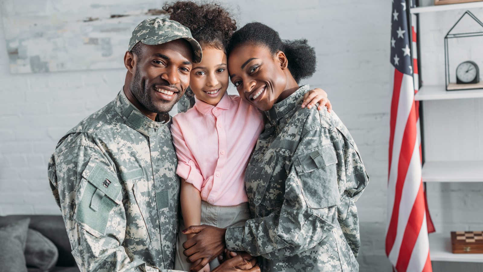 Male and female service members with their child