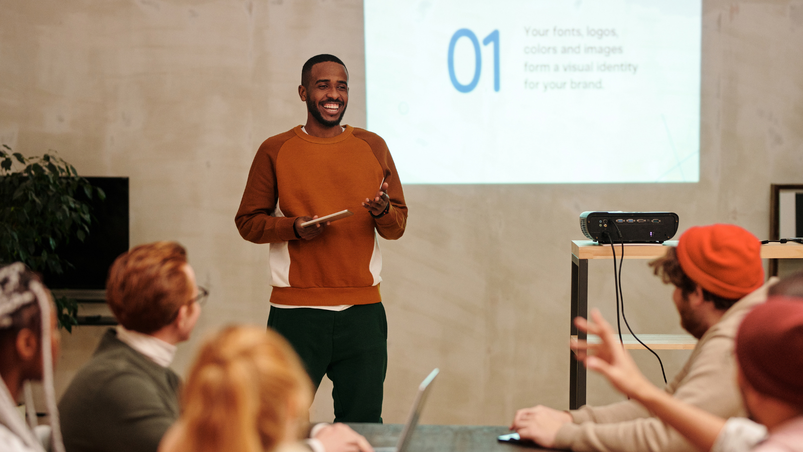 Black man presenting in front of diverse peers