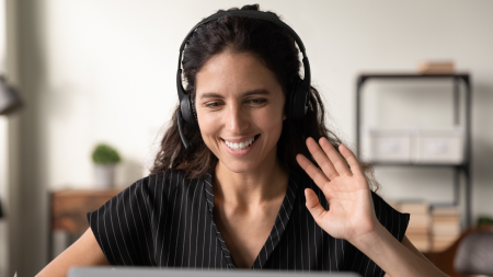 Woman wearing headphones in front of a computer