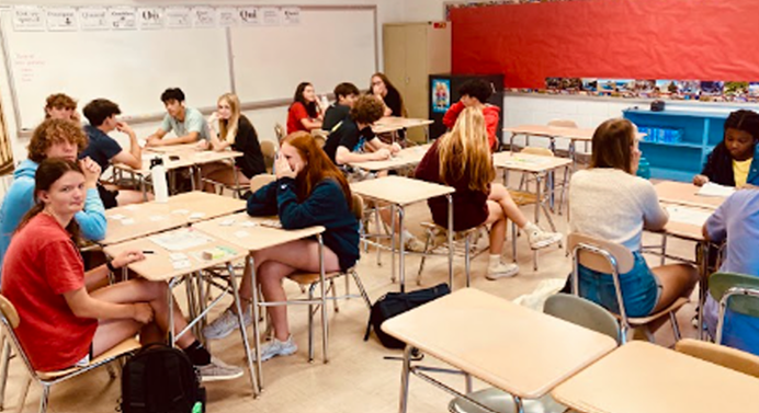 A diverse group of high school students in a classroom at their desks