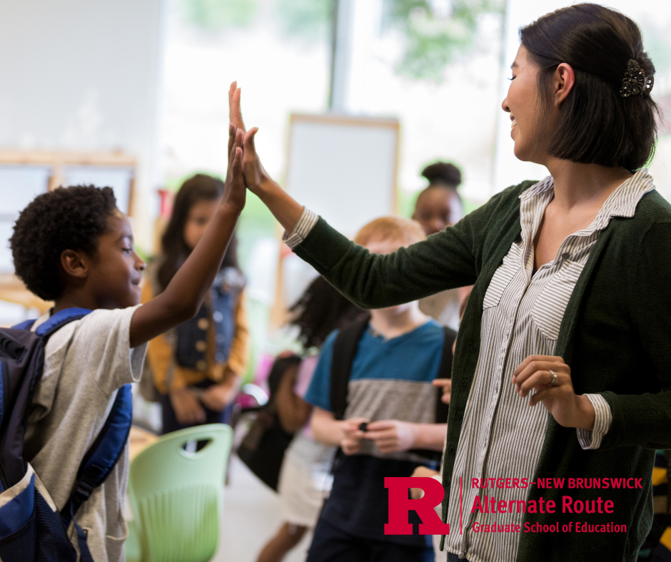 Woman teacher high-fiving an elementary student