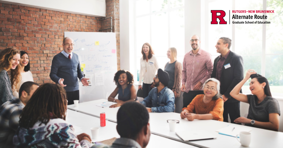 People around a conference table with a whiteboard in front