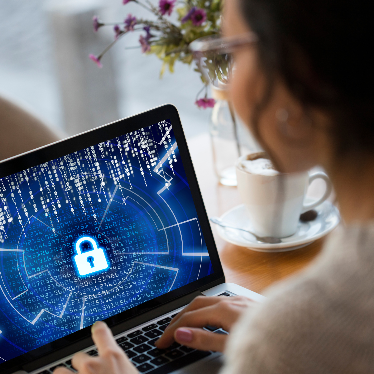 Woman at a computer with a lock graphic on her screen