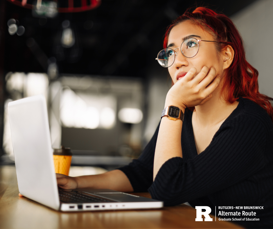 Woman at a laptop resting her chin in her hand and thinking