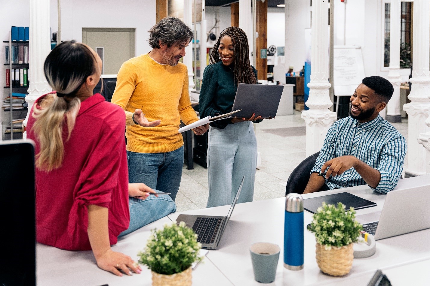 A group of diverse teachers in a library