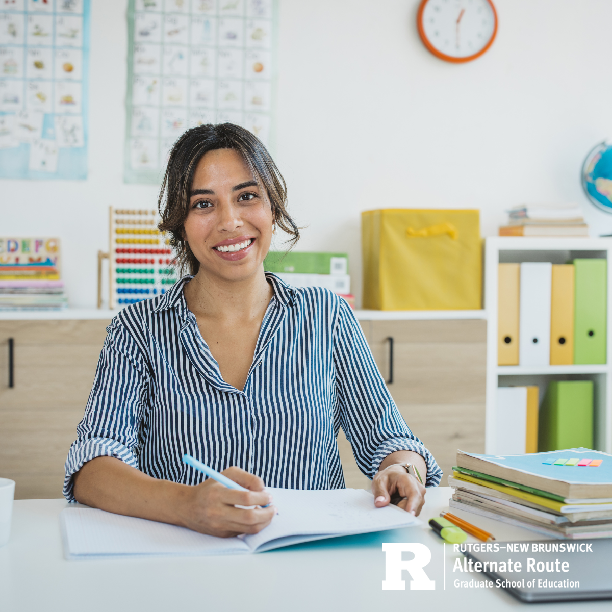 Woman sitting at a desk in her classroom