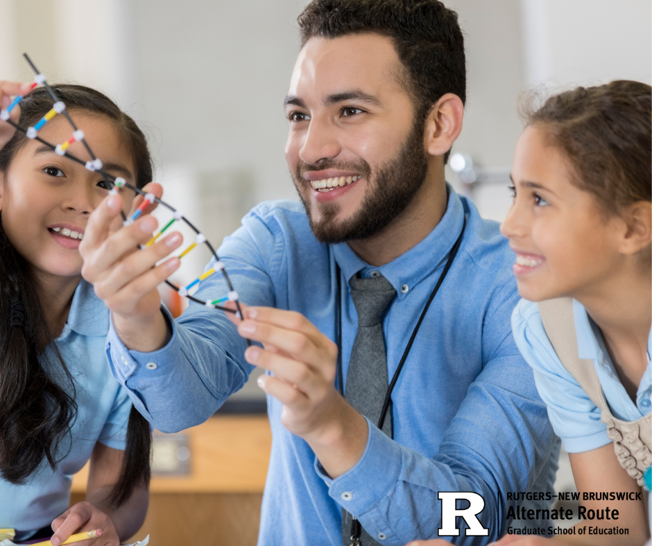 Male substitute teacher working on a science project with two elementary students