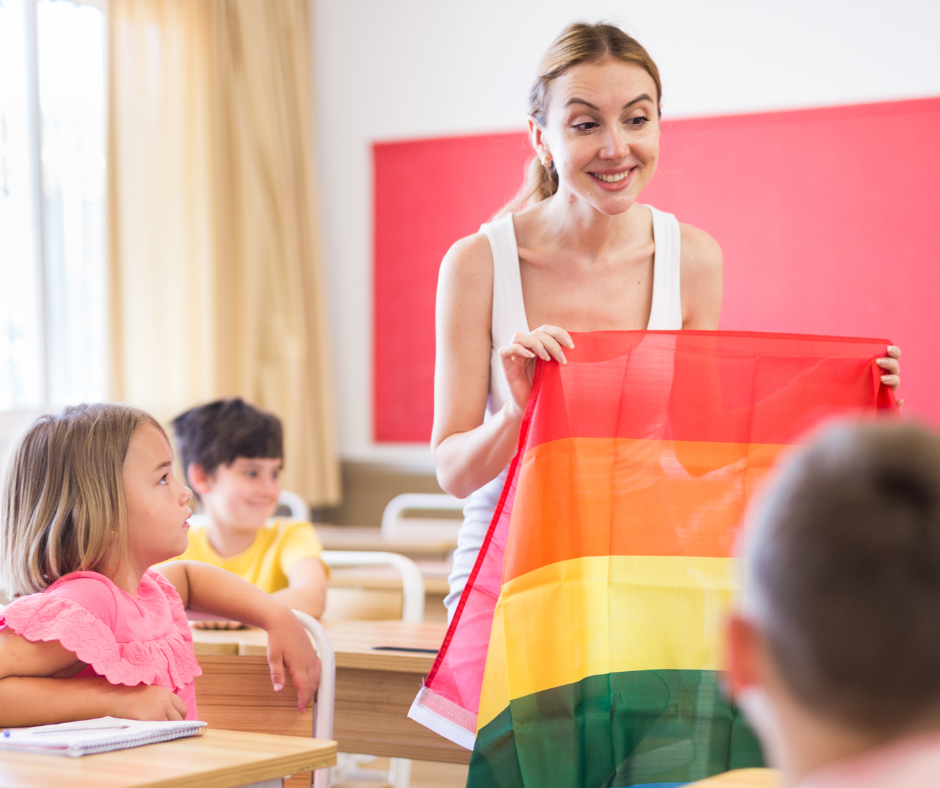 Teacher holding a Pride flag