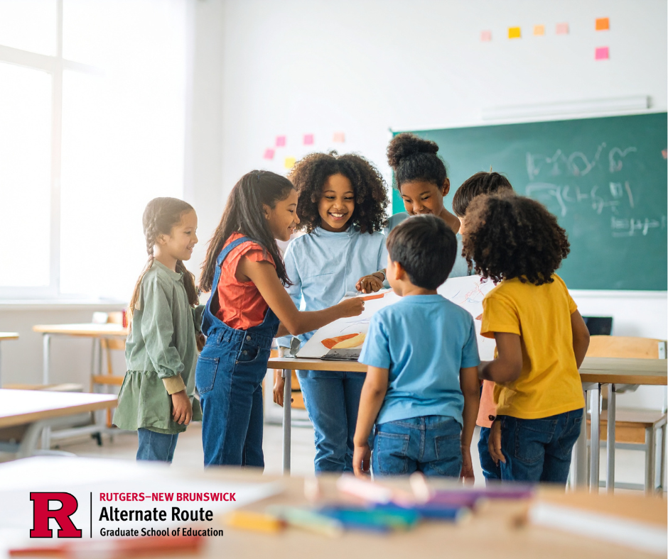 Group of students in a classroom excitedly gathered around a desk, engaged in a learning experience
