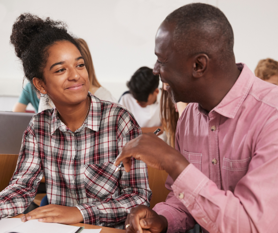 Male teaching mentor working with a female teacher