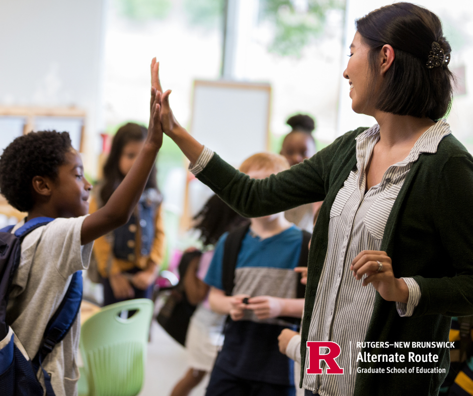Female educator giving an elementary aged child a high-five