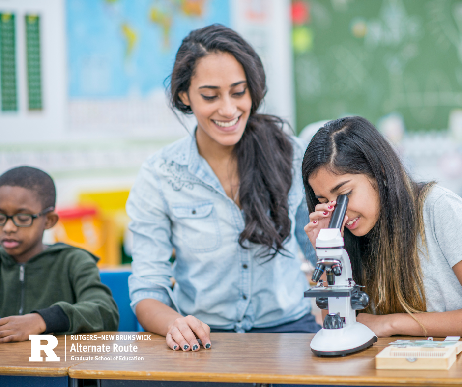 Teacher next to a student looking into a microscope