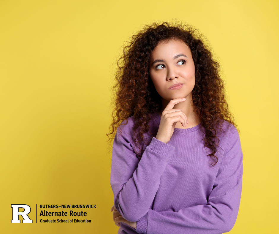 Woman in a purple sweater and curly brown hair thinking