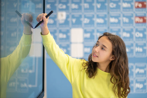 Middle school-aged girl at whiteboard