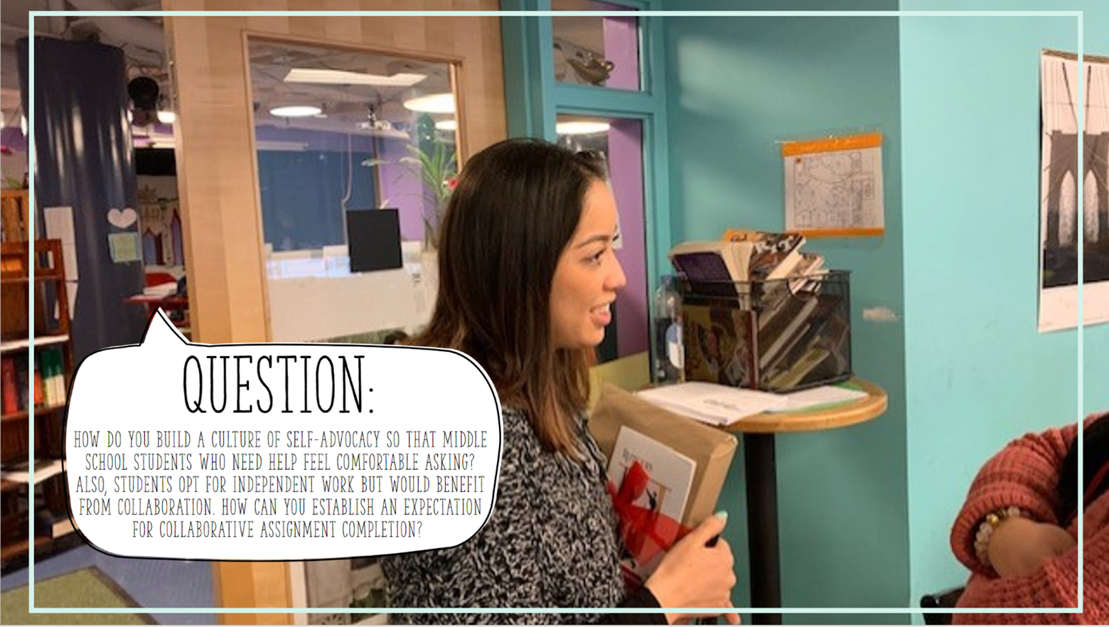 Woman in a classroom speaking to someone outside of the frame