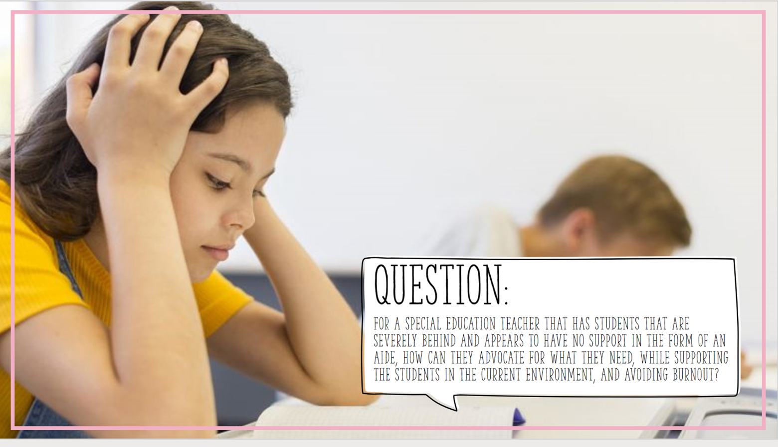 Student leaning over a desk with her hands on her head