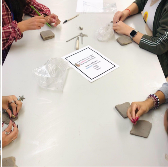 Four students at a table playing ceramic stop