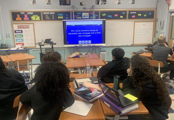 Students in a classroom playing Jeopardy