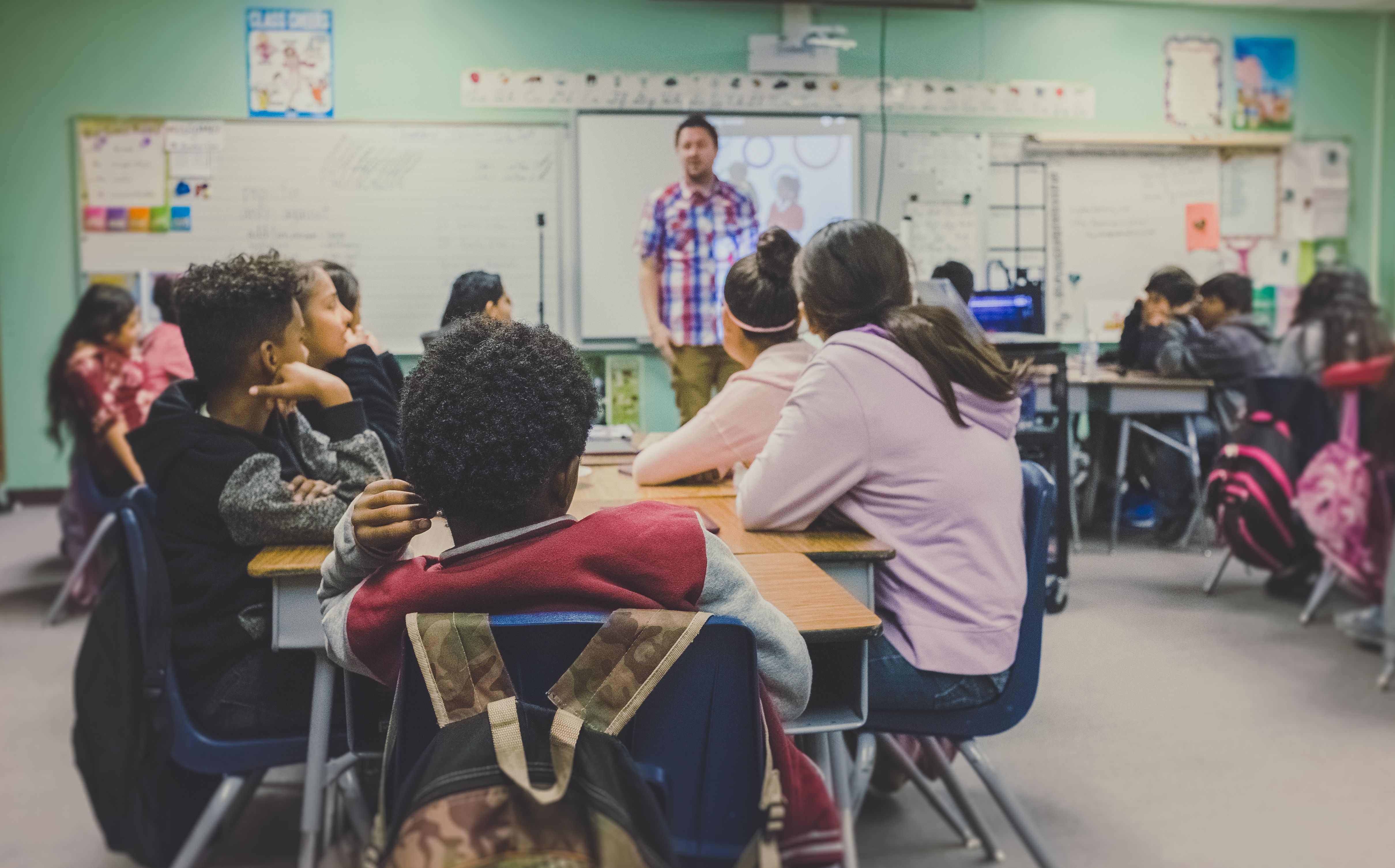 Male teacher in front of classroom