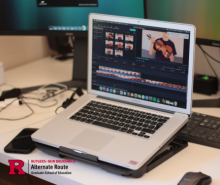 Computer on a desk with the screen featuring a music lesson video