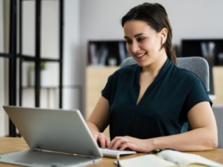 Woman sitting at a computer for a virtual interview 