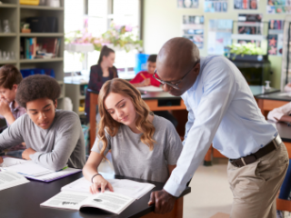 Science teacher helping students in the classroom