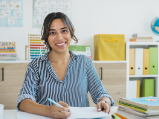 Woman sitting at a desk in her classroom
