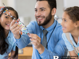 Male substitute teacher working on a science project with two elementary students