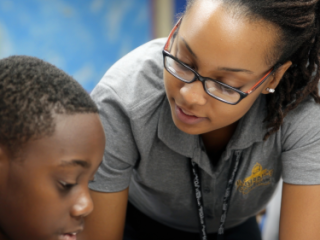Teacher assistant giving one-on-one support to a student