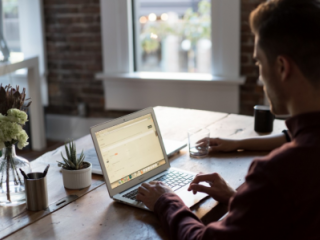 man at desk with laptop