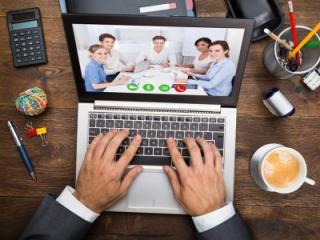 image of a man on a laptop in a virtual meeting