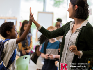 Female educator giving an elementary aged child a high-five