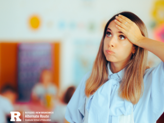 Woman in a classroom with her hand on her forehead, looking stressed