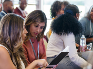 Group of young professionals sitting down at a conference