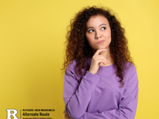 Woman in a purple sweater and curly brown hair thinking