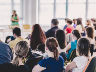 Room of professionals attending a conference