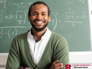 Male teacher of color in front of a chalkboard with math equations