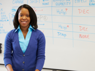 Woman standing in front of a whiteboard with a lesson on it